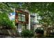 Contemporary home with wood and white exterior and manicured landscaping at 670 Willoughby Ne Way, Atlanta, GA 30312