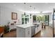Bright, open kitchen featuring stainless steel appliances, a kitchen island and sliding doors to outdoor space at 670 Willoughby Ne Way, Atlanta, GA 30312