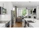 Open concept kitchen with stainless steel appliances overlooking the living room at 670 Willoughby Ne Way, Atlanta, GA 30312
