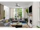 Bright living room featuring a modern fireplace and large windows with a lush view at 670 Willoughby Ne Way, Atlanta, GA 30312