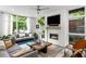 Inviting living room with a cozy fireplace, modern furniture, and plenty of natural light at 670 Willoughby Ne Way, Atlanta, GA 30312