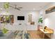 Contemporary living room featuring stylish decor, hardwood floors, and a ceiling fan at 670 Willoughby Ne Way, Atlanta, GA 30312