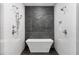 Modern shower with a stone wall, dual shower heads, and a sleek, free-standing white tub at 670 Willoughby Ne Way, Atlanta, GA 30312