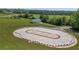 Aerial shot featuring a unique paved racetrack and a functional barn offering a distinctive property feature at 14501 Woolsey Rd, Hampton, GA 30228