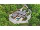 Stunning aerial view of an estate home with lush landscaping and a private pool at 14501 Woolsey Rd, Hampton, GA 30228