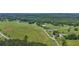 Expansive aerial view of the property showing fields, trees, and road at 14501 Woolsey Rd, Hampton, GA 30228