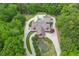 Aerial view of acreage with a log-style home, pool, and water feature at 14501 Woolsey Rd, Hampton, GA 30228