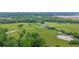 Aerial view showcases estate with tree lined fence and manicured grounds at 14501 Woolsey Rd, Hampton, GA 30228