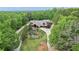 Expansive estate home with meticulously landscaped grounds and a serene water feature; aerial view at 14501 Woolsey Rd, Hampton, GA 30228