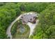 Stunning aerial view of estate home with landscaped grounds, water feature and circular driveway at 14501 Woolsey Rd, Hampton, GA 30228