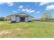 Horse barn with stalls, sliding doors, white siding and green accents situated in a beautiful green pasture at 14501 Woolsey Rd, Hampton, GA 30228