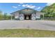 Horse barn with stalls, sliding doors, white siding, and a green metal roof, offering a functional equestrian facility at 14501 Woolsey Rd, Hampton, GA 30228