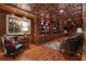 Stylish basement library featuring built-in wooden shelves, plush seating, and decorative ceilings at 14501 Woolsey Rd, Hampton, GA 30228