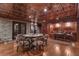 Basement seating and bar area with stone accents, perfect for entertaining guests at 14501 Woolsey Rd, Hampton, GA 30228