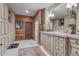 A bathroom with custom cabinets, wooden accents and trim, and a large mirror at 14501 Woolsey Rd, Hampton, GA 30228