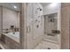 A luxurious bathroom featuring a separate tub and a glass-enclosed shower with stone tiling at 14501 Woolsey Rd, Hampton, GA 30228