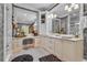Elegant bathroom featuring dual sinks, marble counters, stylish wallpaper, and modern lighting at 14501 Woolsey Rd, Hampton, GA 30228