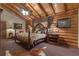 Comfortable bedroom boasts vaulted ceiling and log wall details at 14501 Woolsey Rd, Hampton, GA 30228