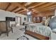 Spacious bedroom featuring wood-beamed ceilings, a seating area, and ample natural light at 14501 Woolsey Rd, Hampton, GA 30228