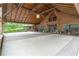 Wide view of a grand carport leading to a luxurious log cabin-style home with a stone base at 14501 Woolsey Rd, Hampton, GA 30228