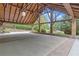 Spacious carport with exposed wood beams and stone pillars, providing ample covered parking at 14501 Woolsey Rd, Hampton, GA 30228
