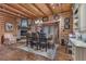 Charming dining room with a stone fireplace, wood-beam ceilings, and a rustic chandelier at 14501 Woolsey Rd, Hampton, GA 30228