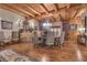 Elegant dining room showcasing wood beams, chandelier, wood floors, and seating for six at 14501 Woolsey Rd, Hampton, GA 30228