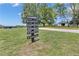 Entrance to the property with directory sign and a white barn at 14501 Woolsey Rd, Hampton, GA 30228