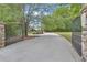 Gated entrance to the property with mature trees and a long driveway at 14501 Woolsey Rd, Hampton, GA 30228
