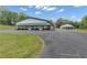 View of the exterior of the building, showing the ample parking and covered patio space at 14501 Woolsey Rd, Hampton, GA 30228
