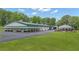Expansive property featuring green roofed buildings and large grassy fields at 14501 Woolsey Rd, Hampton, GA 30228