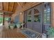 Welcoming front porch with double doors, rustic accents, and manicured landscaping details at 14501 Woolsey Rd, Hampton, GA 30228