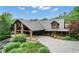 Charming log home featuring a grand entrance, covered porch, and lush landscaping at 14501 Woolsey Rd, Hampton, GA 30228