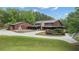 A stunning log home with circular driveway, professionally landscaped yard, and stone chimney at 14501 Woolsey Rd, Hampton, GA 30228