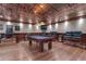Spacious game room featuring a billiards table, leather seating, and decorative paneled walls at 14501 Woolsey Rd, Hampton, GA 30228