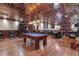 A finished basement game room with pool table, bar and seating areas, custom details, and a phone booth at 14501 Woolsey Rd, Hampton, GA 30228