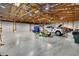 A large garage has a tall ceiling, wooden supports, and space for multiple vehicles at 14501 Woolsey Rd, Hampton, GA 30228