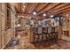 Kitchen with bar seating, stone accents, wooden beams, granite countertop, and professional appliances at 14501 Woolsey Rd, Hampton, GA 30228