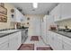 Galley kitchen featuring white cabinetry, stainless steel appliances, and gray countertops at 14501 Woolsey Rd, Hampton, GA 30228