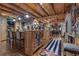 Open-concept kitchen featuring wooden beams, breakfast bar, and seamless flow to the living area at 14501 Woolsey Rd, Hampton, GA 30228