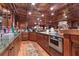 A well-appointed basement kitchen with wood cabinets, granite counters, stainless appliances, and copper-look ceiling at 14501 Woolsey Rd, Hampton, GA 30228
