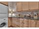 Convenient laundry room features wood cabinets, utility sink, and modern appliances at 14501 Woolsey Rd, Hampton, GA 30228