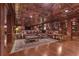Finished basement with leather sofas, hardwood floors, copper-look ceiling, and built-in bookshelves at 14501 Woolsey Rd, Hampton, GA 30228