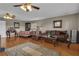 Open-concept living and sleeping area with hardwood floors, ceiling fans, and a sitting area at 14501 Woolsey Rd, Hampton, GA 30228
