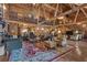 Expansive living room featuring exposed beams, hardwood floors, and ample seating at 14501 Woolsey Rd, Hampton, GA 30228