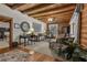 Inviting living room with wood beam ceilings and elegant furnishings, perfect for relaxation and entertaining at 14501 Woolsey Rd, Hampton, GA 30228