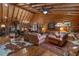 Spacious living room with high wooden ceilings, plush seating, and elegant decor and wood floors throughout at 14501 Woolsey Rd, Hampton, GA 30228