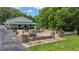 Expansive stone patio featuring a fire pit and outdoor seating, perfect for entertaining at 14501 Woolsey Rd, Hampton, GA 30228