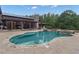 Backyard with a freeform pool, spa, waterfall and stone patio, perfect for outdoor enjoyment at 14501 Woolsey Rd, Hampton, GA 30228
