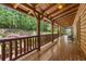 Inviting covered porch with wood railing, offering a serene outdoor living space at 14501 Woolsey Rd, Hampton, GA 30228